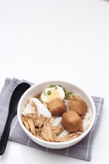 Thai food, Chinese roll noodle soup served in white cups on a white table.