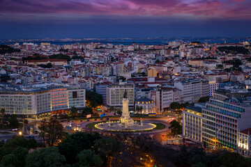 Fototapeta na wymiar The skyline of Lisbon, Portugal, with Marques de Pombal square and Alfama district in the background during evening time