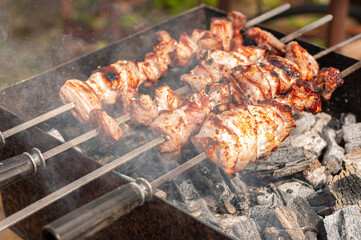 Marinated shashlik preparing on a barbecue grill over charcoal. Shashlik or Shish kebab popular in Eastern Europe
