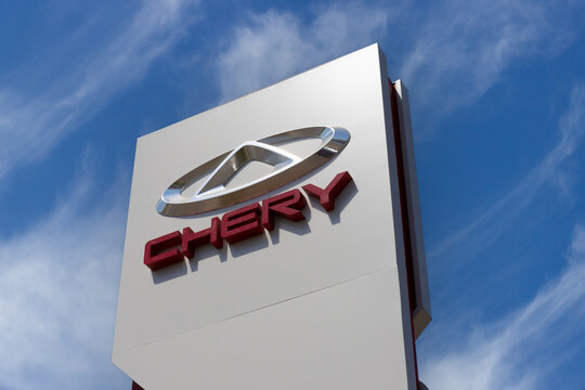 Krasnoyarsk, Russia - May 19, 2022: Close-up Chery brand logo on against blue sky background. Dealership centre of car shop