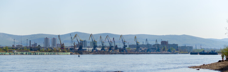 Panorama river Yenisei Siberia. Port docks in the city of Krasnoyarsk. Loading cranes