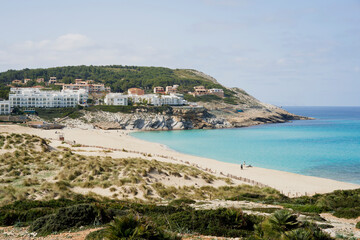 Fototapeta na wymiar Cala Mesquida white sand beach with crystal clear waters between pine trees and dunes on the northeast coast of Majorca