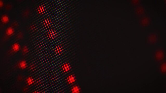 Abstract motion of red dots on a dark background, soft focus