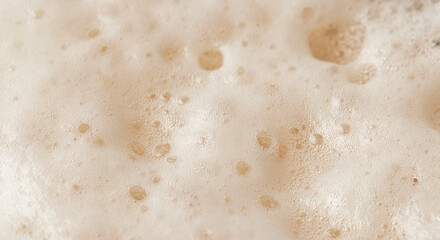 Beer foam top view. Soft fresh Foam on light beer. Bubble froth of beer. Beer foam texture background