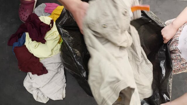 Clothing and textiles for recycling. Old used things are collected in a garbage bag