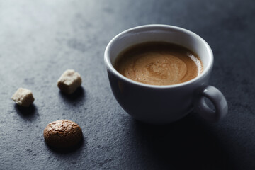 Cup of coffee on dark stone background. Close up. Copy space.