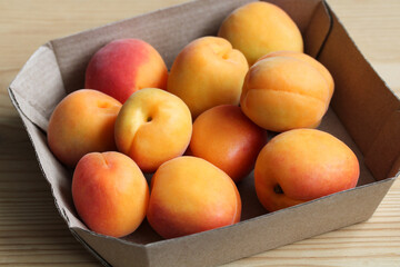 apricots on a paper tray, top view.