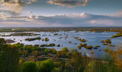 Views of a wide-spread river with islands from a high bank