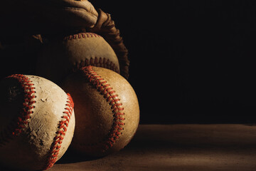Old baseball equipment used from sports game shows vintage background with copy space.