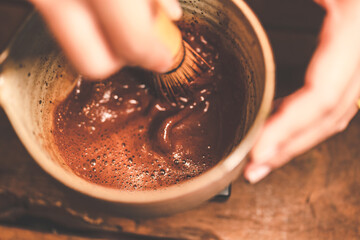 professional barista making beverage chocolate drink from dark cocoa powder in brown mug with hot milk, having sweet aroma in cup at vintage cafe background in the morning breakfast - obrazy, fototapety, plakaty