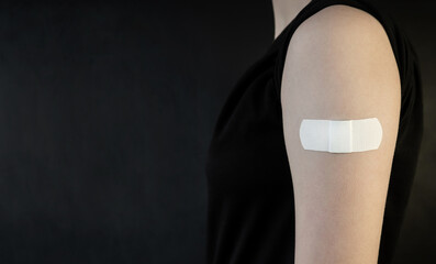 vaccinated girl. Bandage on the shoulder after vaccination against Smallpox, Covid-19. Virus,...