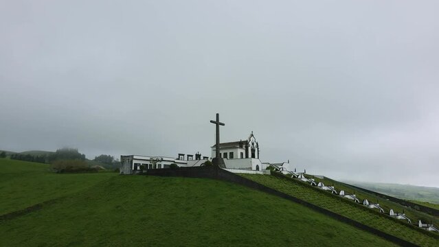 Beautiful chapel on a green hill in the fog - Chapel Ermida de Nossa Senhora, Azores, Sao Miquel, Portugal - 4k drone shot #3