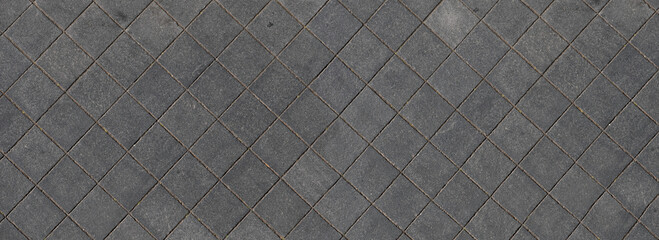 Sidewalk of square paving stones seen from above, widescreen image