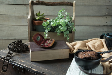 Bowl of brownies on a rustic wooden trunk near a white washed plank board wall. Break time treat.