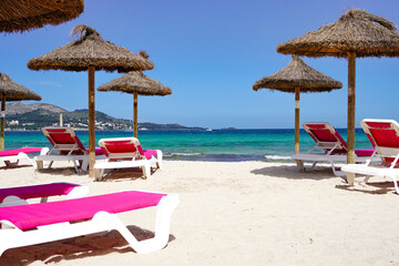 beach chairs and umbrella on Muro beach, Alcúdia bay in Mallorca
