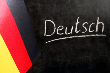 Fototapeta na wymiar Flag of Germany and a chalkboard with the inscription Deutsch.