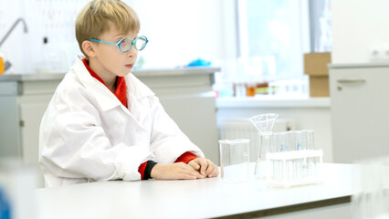 a student in a chemical laboratory conducts chemical sweats with chemical elements