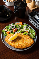 schnitzel with fresh sald and lemon