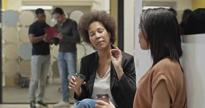 Black women talking during coffee break