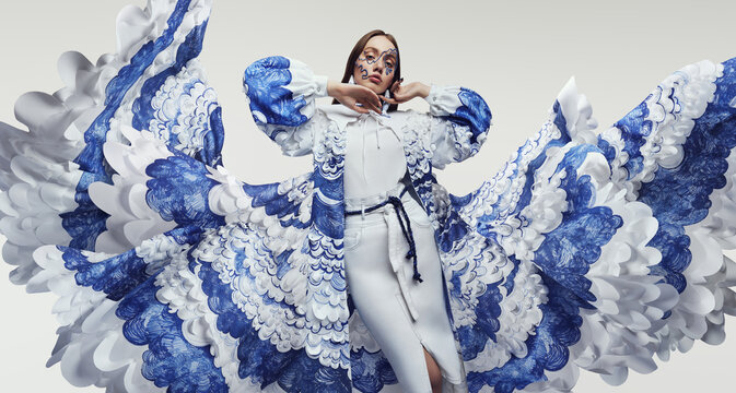 Woman in amazing flying dress with blue and white waves and mask