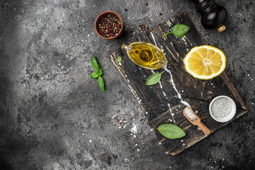 Dark cooking background. Herbs and condiments on stone background. Top view. copy space