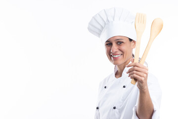 Portrait of happy caucasian woman looking at camera in chef outfit with kitchen tools in hands isolated on white background. with copy space.