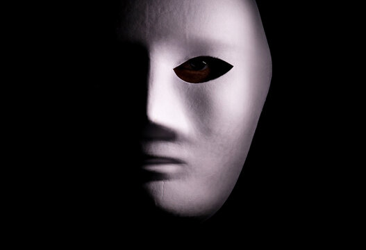 portrait of a person with a mask on a dark background