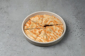 sliced flatbread on gray background