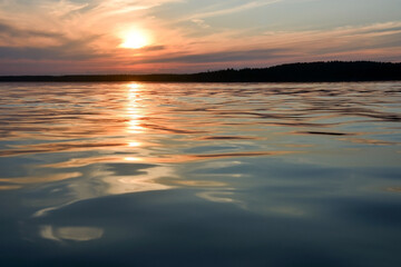 Fototapeta na wymiar Sunset on the forest lake 