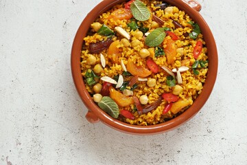 Vegan Moroccan Bulgur with Chick Peas, spinach, dried apricots and date fruit. Traditional African Tajine dish. Flat layot