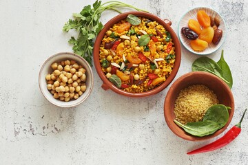 Vegan Moroccan Bulgur with Chick Peas, spinach, dried apricots and date fruit. Traditional African...