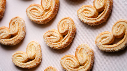 Delicious appetizing pretzels with sugar puff pastry background
