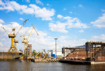 Shipyard in Szczecin seen from the water, Poland. - obrazy, fototapety, plakaty