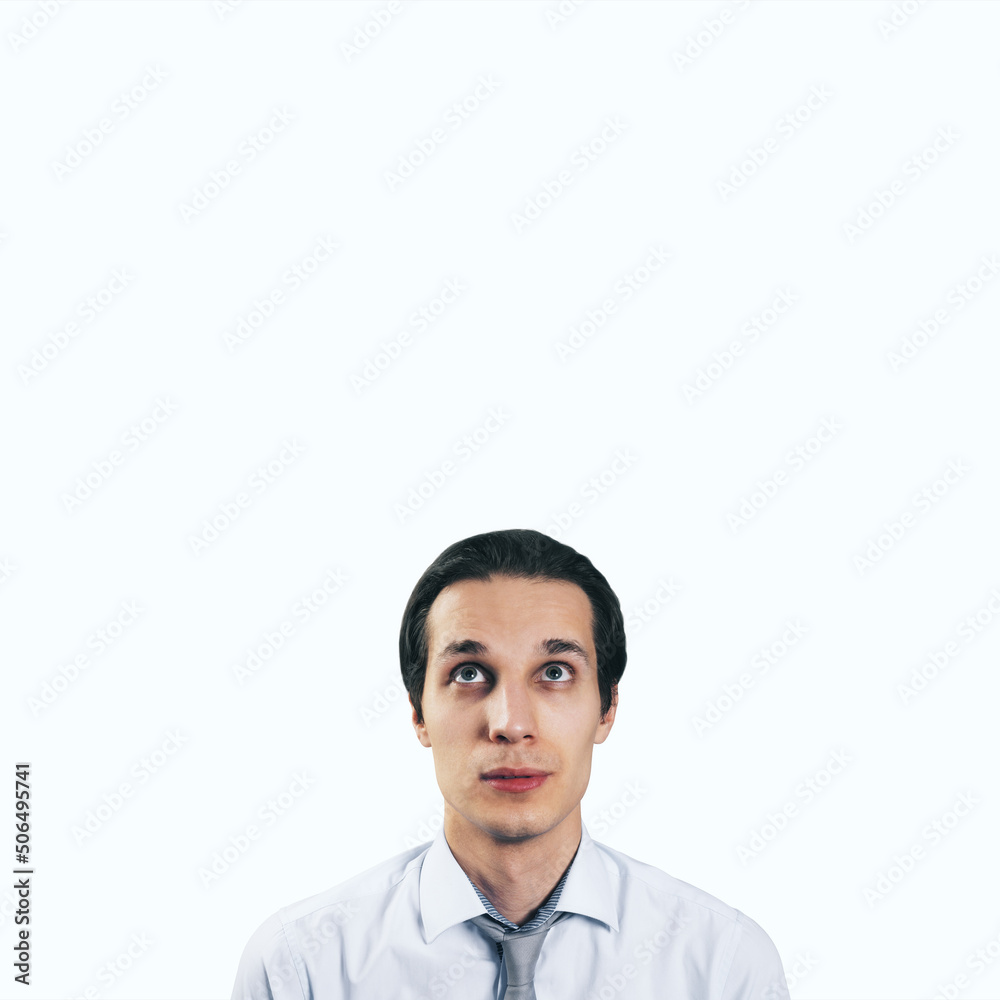 Poster Man looking up in white shirt and tie isolated on blank light background with empty space for your text or logo, mockup. Thinking and brainstorming concept, close up
