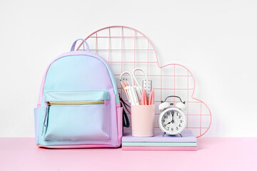 Blue backpack with school stationery on white background. Office supplies with school bag and pencil holder on the table. Concept back to school.