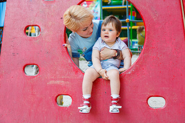 Fototapeta premium beautiful girl with children on a children's playground