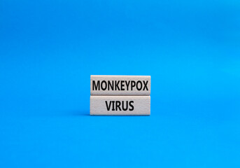 Monkeypox virus symbol. Concept word Monkeypox virus on wooden blocks. Beautiful blue background. Medicine and Monkeypox virus concept. Copy space