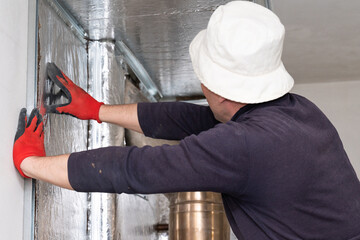 Mineral wool with foil, thermal protection for the wall from the fireplace, installation of metal beacons, screwing the beacons to the wall with a screwdriver.