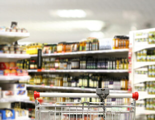 choosing a dairy products at supermarket.empty grocery cart in an empty supermarket