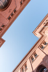 Two modernized brick houses facing each other with clear blue sky