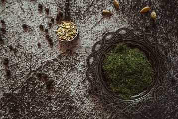 dried dill, fennel, spices and herbs on a gray concrete background 1