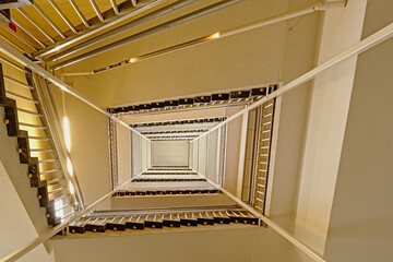 Rectangular staircase over seven floors in the old abandoned city library of Ghent, Belgium, seen from below 