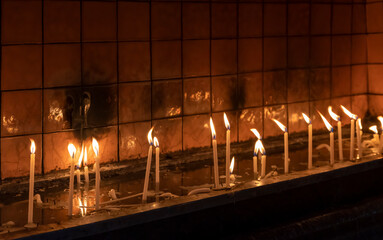 candles burning inside the church. christian ceremony. Close up