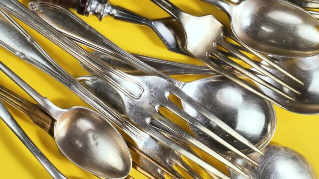 Old kitchen silverware on a bright, colored background
