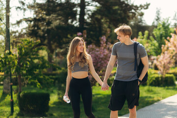 Athletic couple communicate after training. Summer. Healthy lifestyle concept