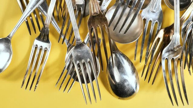Old kitchen silverware on a bright, colored background
