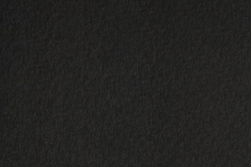Black paper grain texture background.