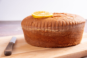 Orange cake over wooden surface, selective focus.