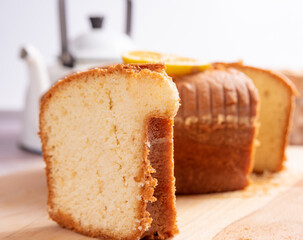 Sliced ​​orange cake over wooden surface, selective focus.