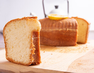 Sliced ​​orange cake over wooden surface, selective focus.